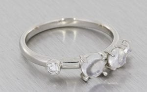 A Contemporary Engagement And Wedding Ring Set Made In Platinum Using Diamonds And Luminescent Cabochon Moonstones