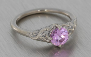 Organic Molten texture ring set with a pale pink sapphire