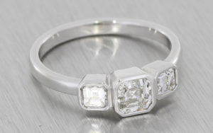 White gold and asscher cut diamond contemporary trilogy ring