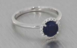18k White Gold Ring Set with a Beautiful Sapphire Surrounded by a Cluster of Diamonds