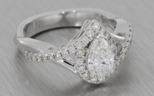 Pear diamond halo engagement ring with organic detail