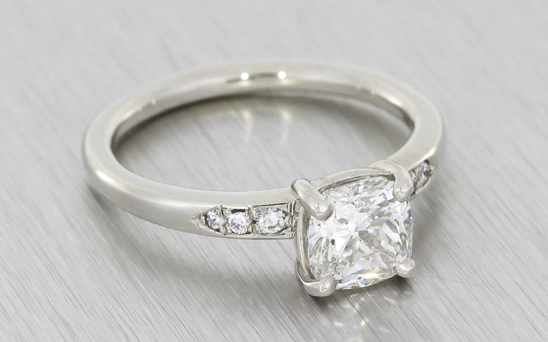 Incredible cushion cut diamond platinum ring with diamond set shoulders