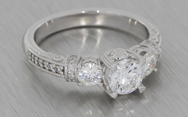 18K white three stone diamond ring with grain set shoulders