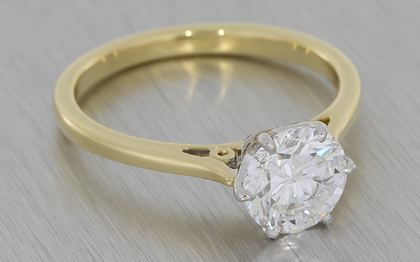 Traditional Solitaire diamond ring set in platinum on a yellow gold band